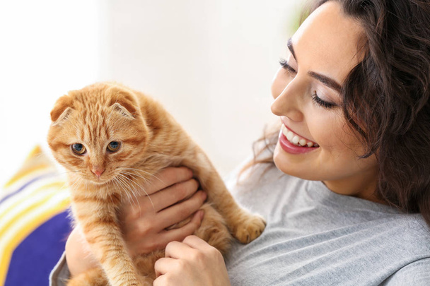 junge Frau mit süßer lustiger Katze zu Hause - Foto, Bild