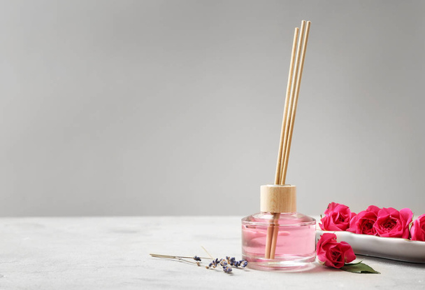 Diffuseur roseau rose sur table
 - Photo, image