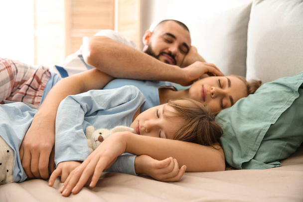 Happy family sleeping in bed at home - Fotó, kép