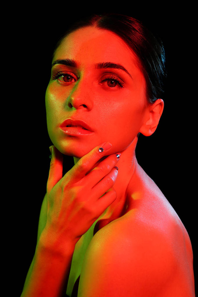 Toned portrait of beautiful young woman on dark background - Fotoğraf, Görsel