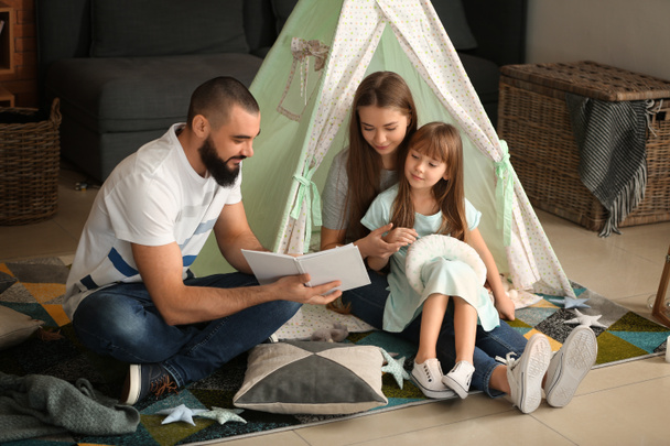 Happy family reading book at home - Fotografie, Obrázek