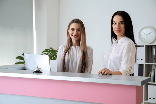 Female receptionists at desk in hotel - Photo, Image