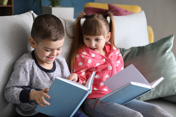 Cute little children reading books at home - Foto, Imagen