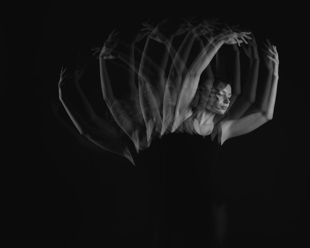 Stroboscopic photo of beautiful moving young woman on dark background - Fotografie, Obrázek