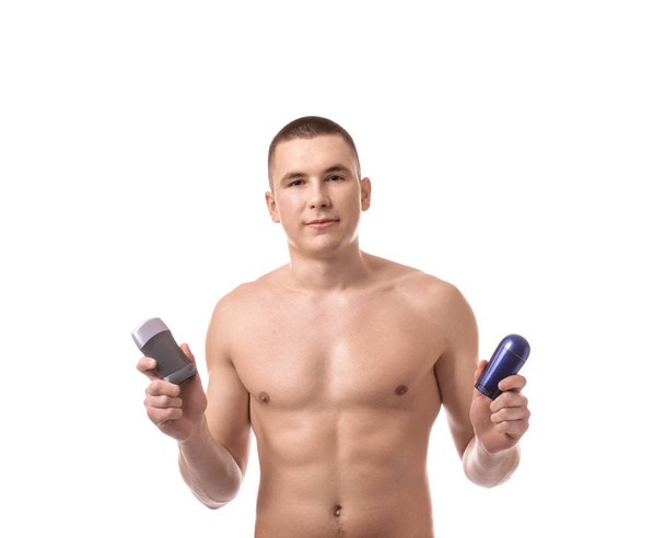 Handsome young man with deodorants on white background - Foto, Imagem