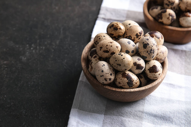 Bowls with quail eggs on table - Фото, изображение
