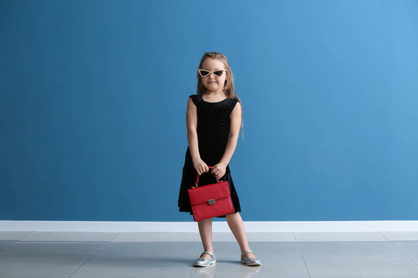 Fashionable little girl against color wall - Valokuva, kuva