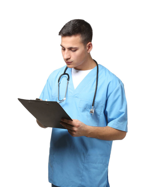 Male doctor with clipboard on white background - Fotó, kép