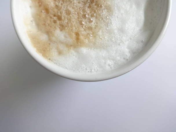 Cappuccino with Foam in a White Mug on White Background - Фото, зображення