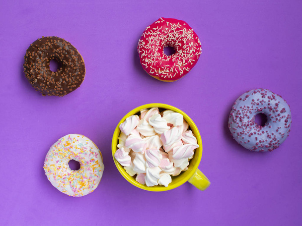 mix donuts with marshmallow on purple background - Photo, Image