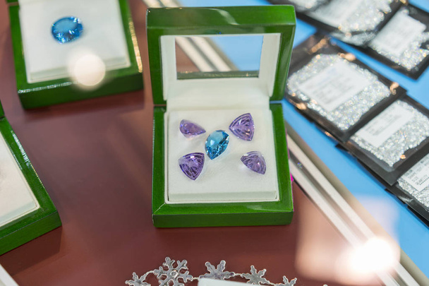 lila und blaue Juwelen in einem Etui. Rubine in einem Koffer - Foto, Bild