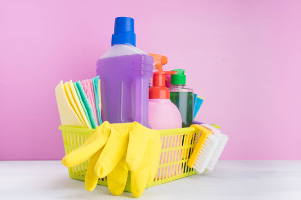 set in a yellow basket of liquid and powder products and items for cleaning indoors on a pink background - Φωτογραφία, εικόνα