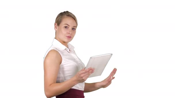 Female office clerk walking with tablet and smiling broadly when talking to camera on white background. - Video, Çekim