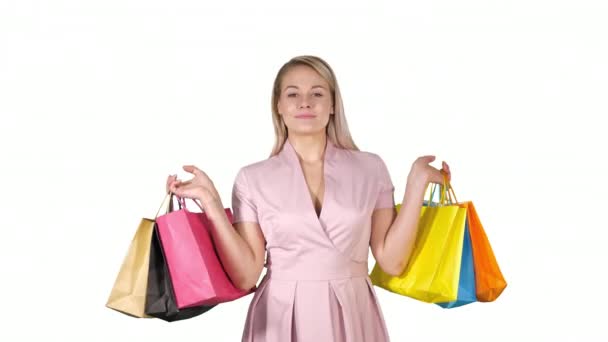 Shopping woman happy smiling holding shopping bags iwhile walking on white background. - Metraje, vídeo