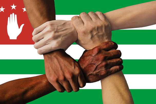 abkhazia flag, intergration of a multicultural group of young people. - Photo, Image