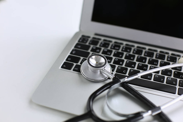 Stethoscope lying on a laptop keyboard in a concept of online m - Φωτογραφία, εικόνα