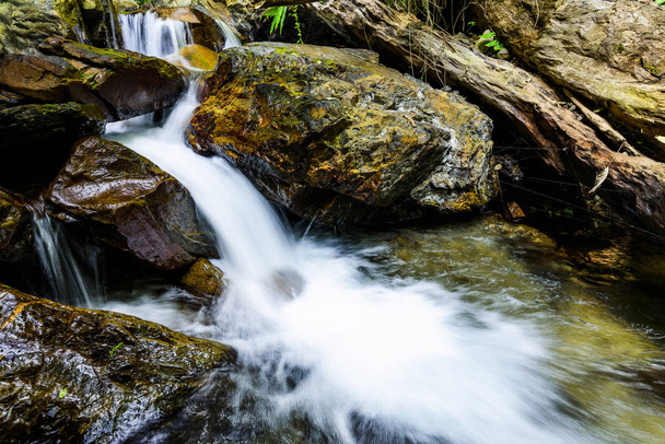 Close-up of a creek or stream water flowing past stones. - Photo, Image