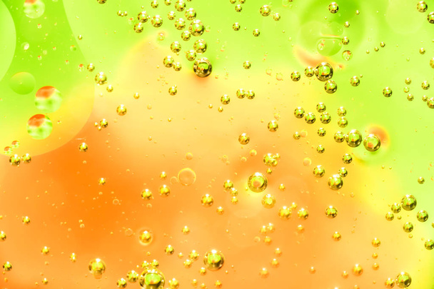Water and oil bubble yellow orange background. Macro shot of beautiful water and oil bubble background , with small and big bubbles - Фото, зображення