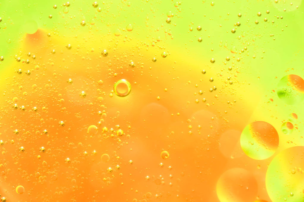 Water and oil bubble yellow orange background. Macro shot of beautiful water and oil bubble background , with small and big bubbles - Φωτογραφία, εικόνα