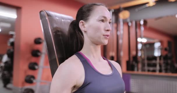 Strong woman working out with dumbbells - Video