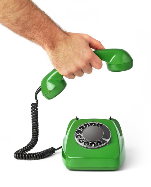 Рука тримає старий телефонний приймач
 - Фото, зображення