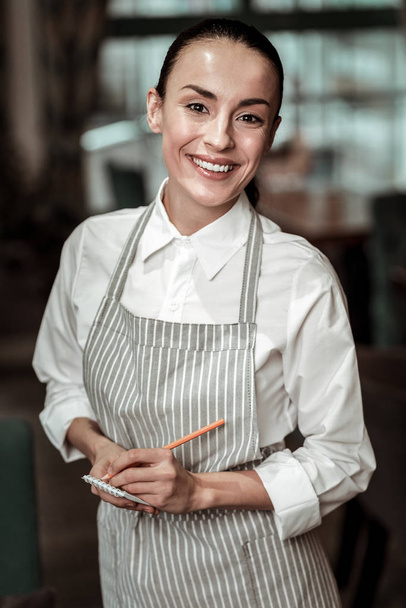 Portrait of happy female person that taking order - Foto, afbeelding