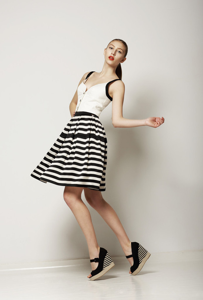 Fashion Style. Happy Young Shopper in Contrast Striped Grey Skirt. Movement - Foto, Bild