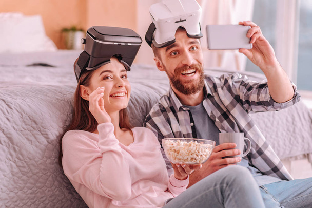 Cheerful man and woman making selfie at home - Foto, immagini