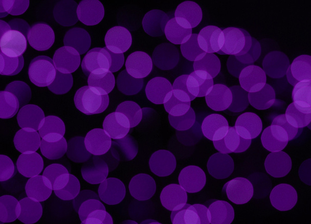 purple circles of light on black background - Foto, imagen