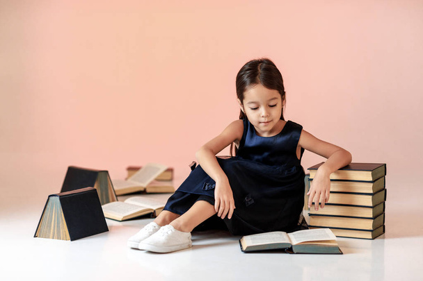 cute little girl is reading a book. - Фото, зображення
