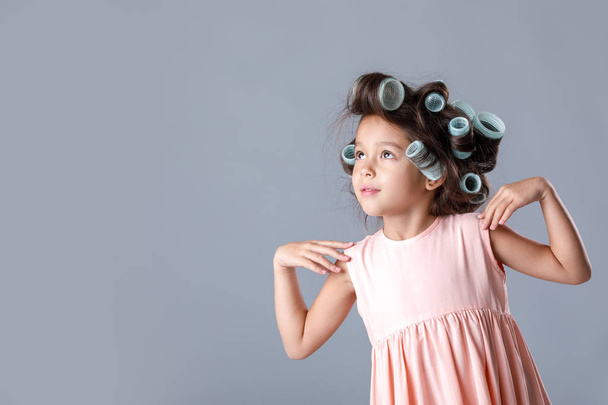 cute little child girl in pink dress and hair curlers - Foto, Bild