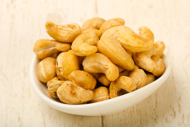 Cashew nuts heap in white bowl - Fotografie, Obrázek