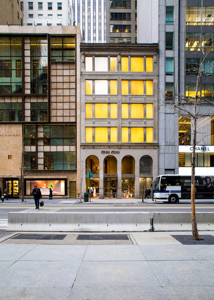 NUEVA YORK CITY - 30 DE DICIEMBRE DE 2016: Vista de tiendas de lujo a lo largo de la Quinta Avenida en Manhattan con gente y autobús MTA visible
. - Foto, imagen
