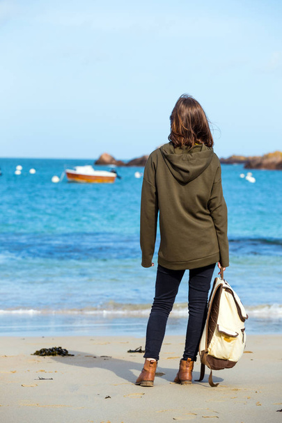 pretty girl walking on the shore of the sea at  the Tregastel, normandy. Franc - Фото, зображення