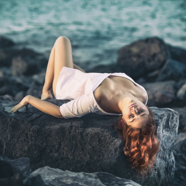 Portrait of a beautiful sexy woman outdoor. Model near the sea - Photo, Image