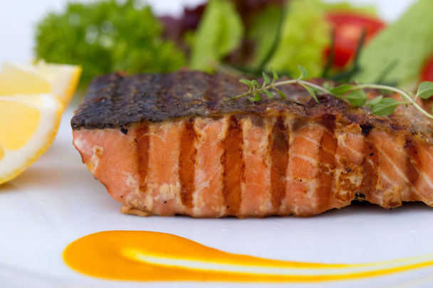 Grilled salmon fillets with salt pepper and herb decoration. - Zdjęcie, obraz