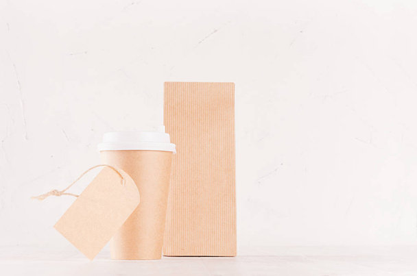 Mockup packing for coffee products and shop - brown paper cup with blank label and packet on white wood board, copy space. - Photo, Image