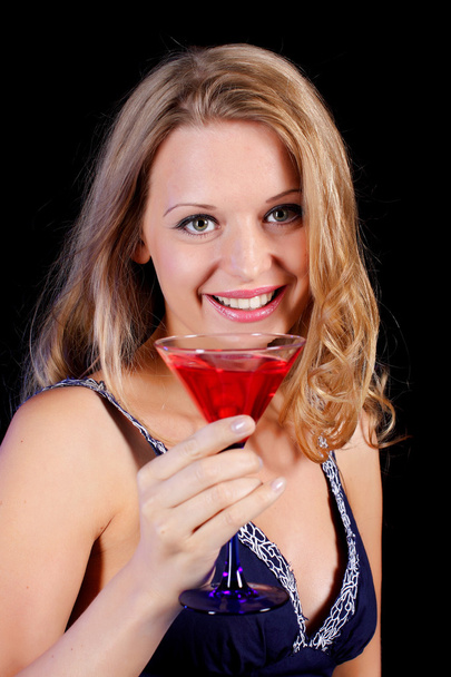 a charming young lady holding a glass of red wine - Фото, зображення