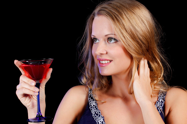 a charming young lady holding a glass of red wine - Foto, Bild