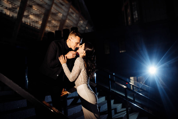 Beautiful young couple  posing at night - 写真・画像