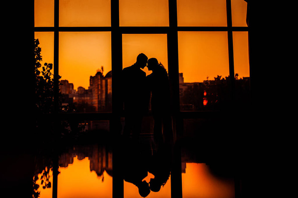 Beautiful young couple  posing at sunset - 写真・画像