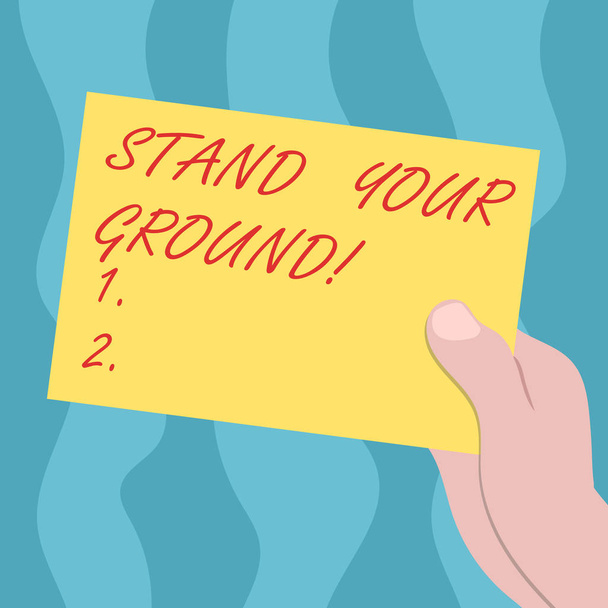 Conceptual hand writing showing Stand Your Ground. Business photo text maintain ones position typically in face of opposition Drawn Hu analysis Hand Holding Blank Color Paper Cardboard. - Photo, Image