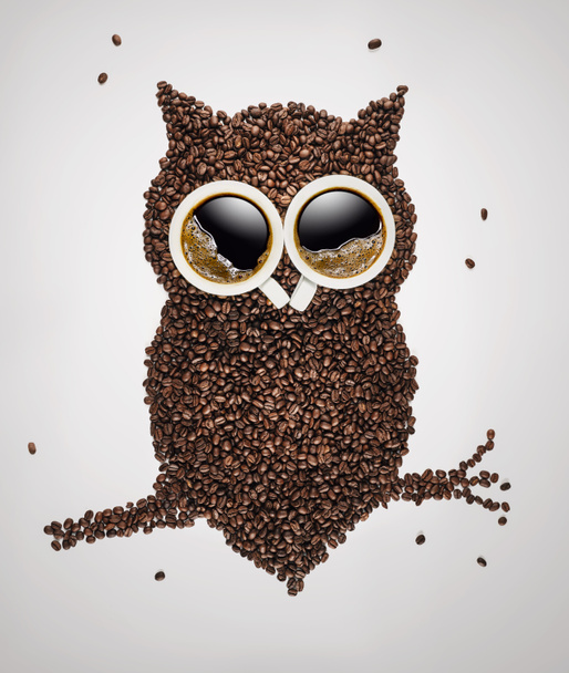 Cute owl sitting on the branch, made of coffee beans and coffee cups over light gray background with copy space - Photo, Image