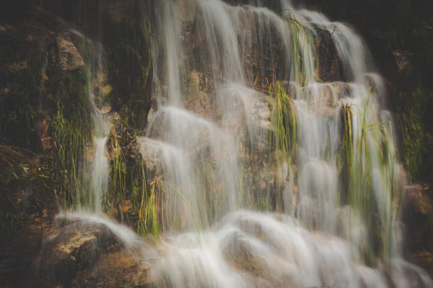Close up image of a waterfall on rocks captured with a slow shutterspeed - Fotografie, Obrázek