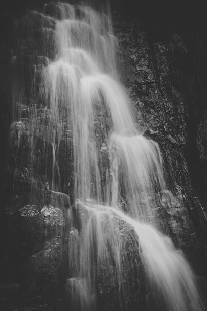 Close up image of a waterfall on rocks captured with a slow shutterspeed - Fotografie, Obrázek