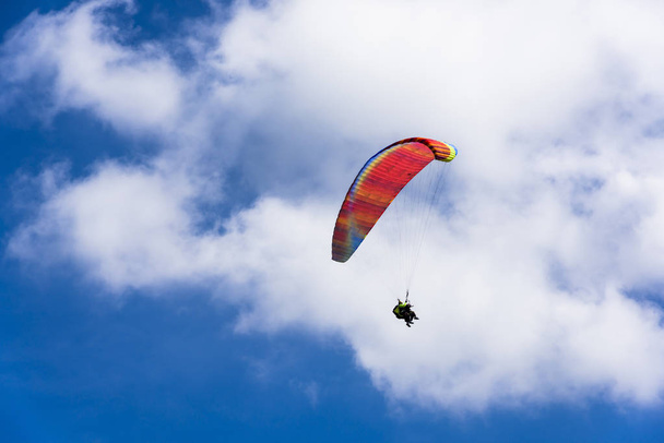 Paragliding extreme Sport with blue Sky and clouds on background Healthy Lifestyle and Freedom concept - Фото, зображення