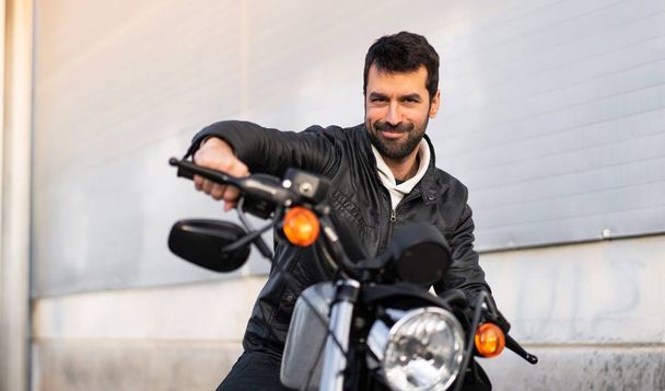 Happy young man on a motorbike - 写真・画像