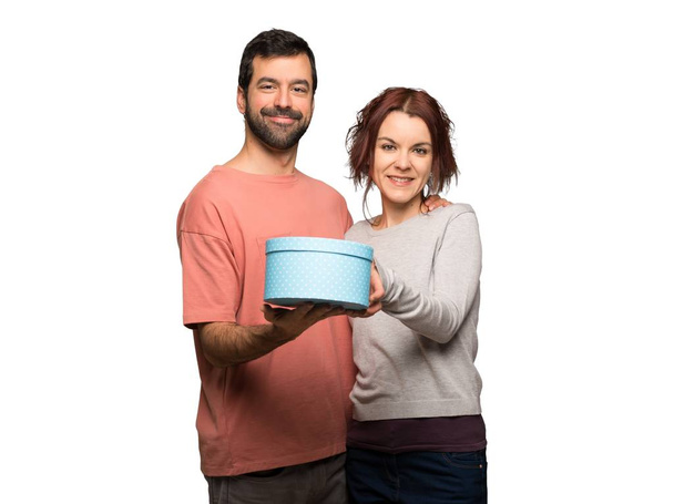 Paar am Valentinstag hält ein Geschenk in den Händen auf isoliertem weißem Hintergrund - Foto, Bild