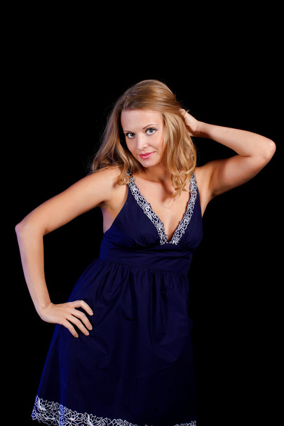 a charming young blonde on a black background - Foto, Bild