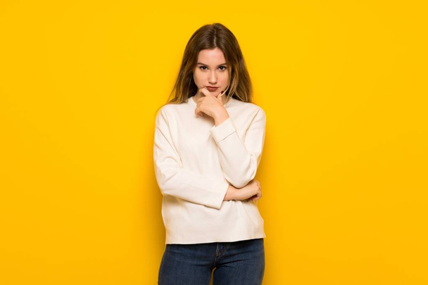 Teenager girl over yellow wall smiling and looking to the front with confident face - Photo, Image